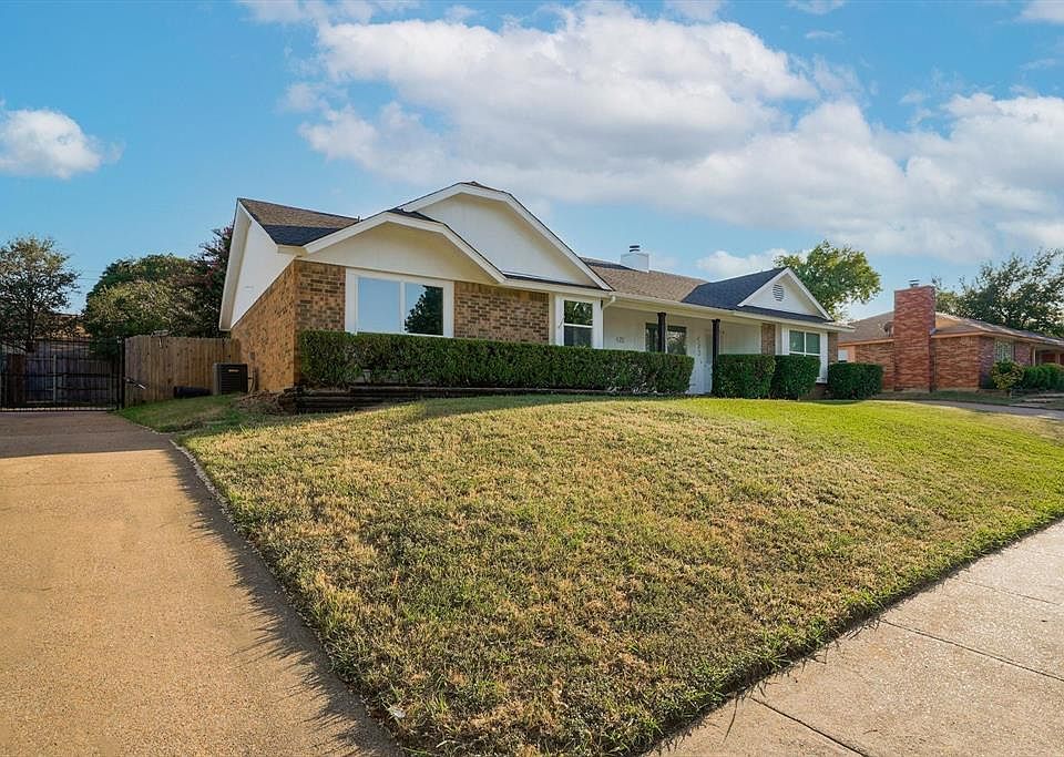 Ranch-style home featuring brick siding