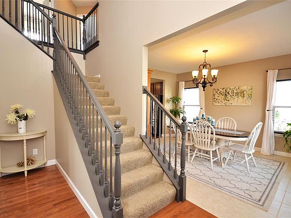 Entry with view into the Dining Room.  Hardwood floors run through the main hall into the Kitchen and breakfast room.