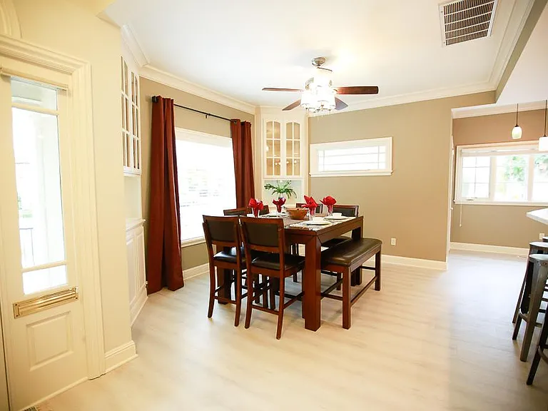 The large square dining table can seat 8 and features 6 nice cushioned chairs and 1 bench. Plenty of room on all sides and a large picture window with lots of natural light.
