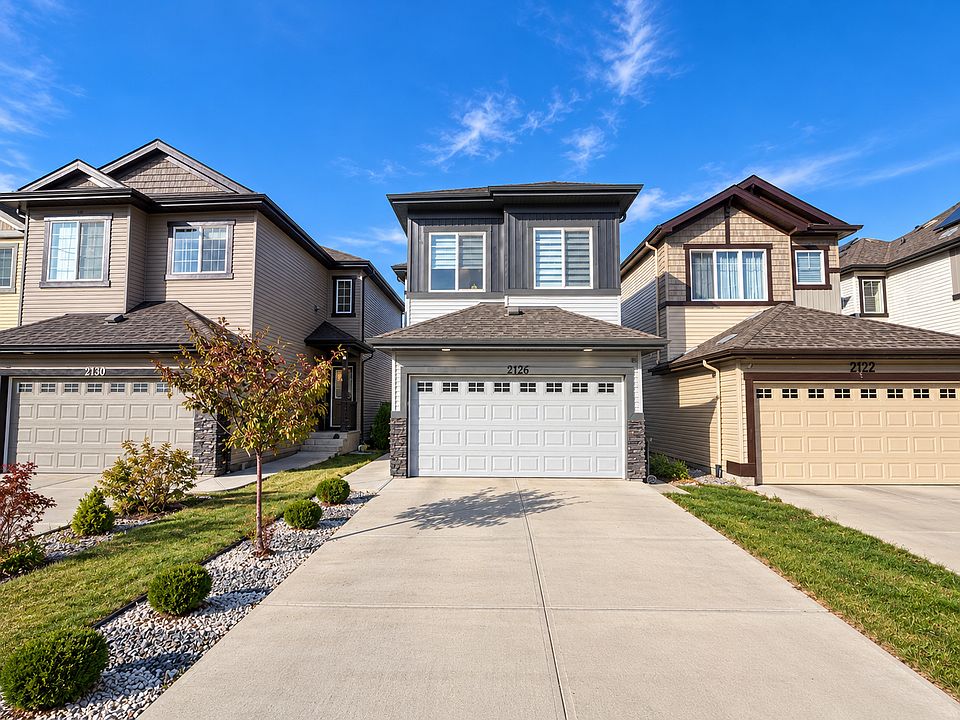 Modern Suburban Homes Under Blue Skies_10022026