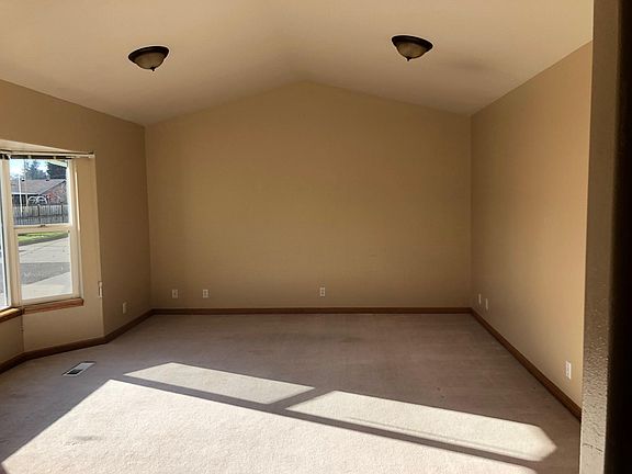 Large front room with bay window and pull down blinds.