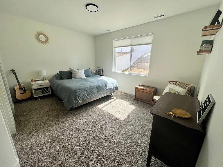 Master bedroom with walk-in closet and attached bathroom.