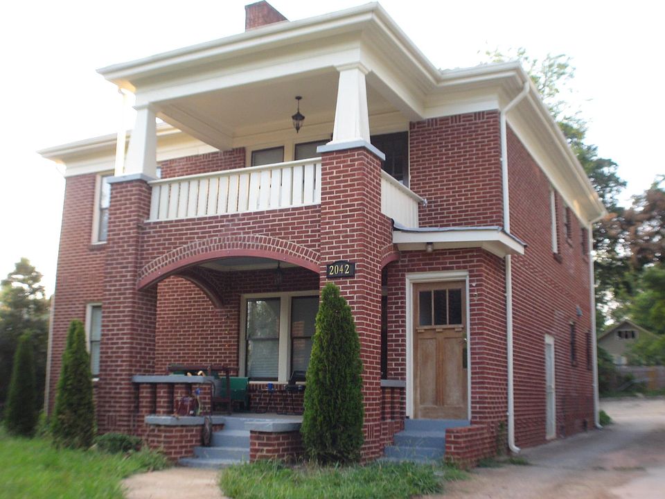 1910 South-facing classic brick apartment building with off-street parking in back. Entire upper level shown is the actual unit for rent.