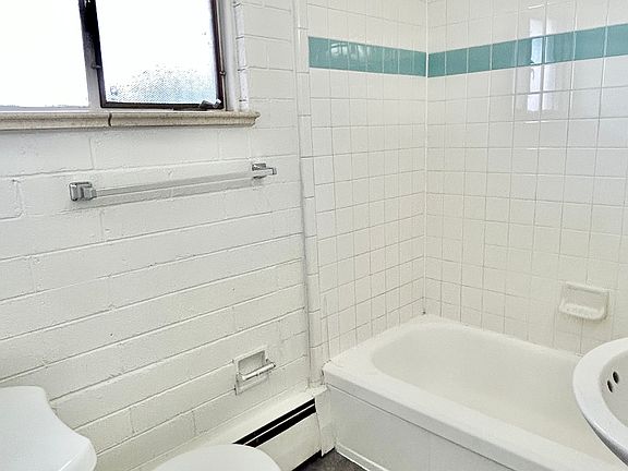 Enjoy the elegance of a contemporary bathroom with crisp white tiles and modern amenities. Enjoy the elegance of a contemporary bathroom with crisp white tiles and modern amenities.