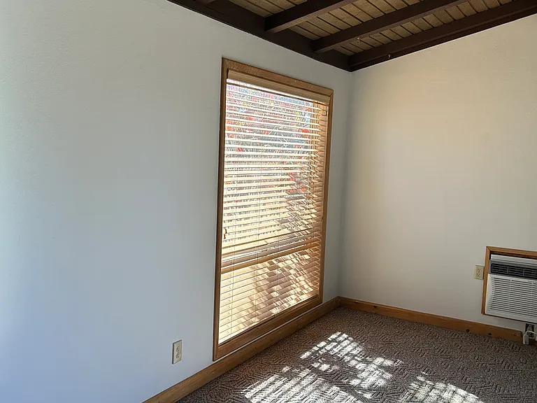 Living room area with air conditioner unit.