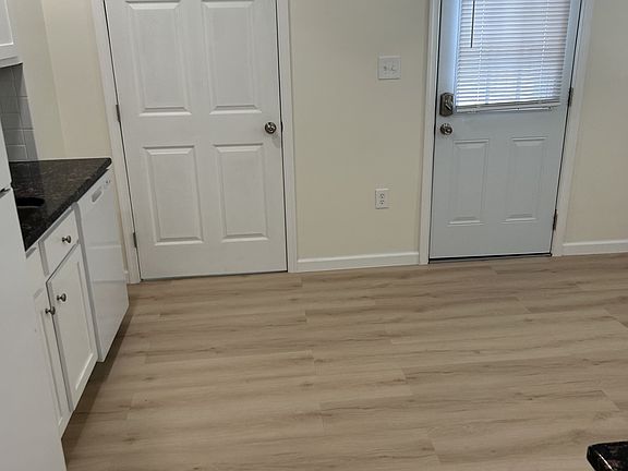 kitchen, 12x15. inside door leads to 1st floor half bath. outdoor door leads to back covered porch, yard, and parking area.