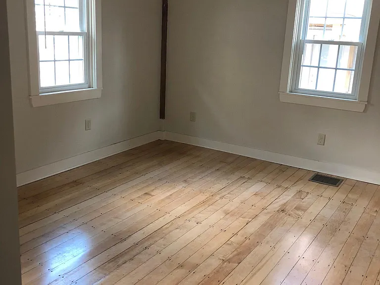 Bedroom with refinished hardwood floors