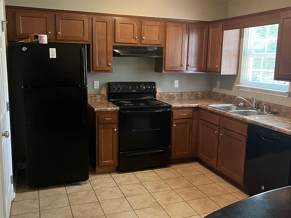 Kitchen is roomy with ample cabinet space. The Laundry/half bathroom conveniently located to the left.