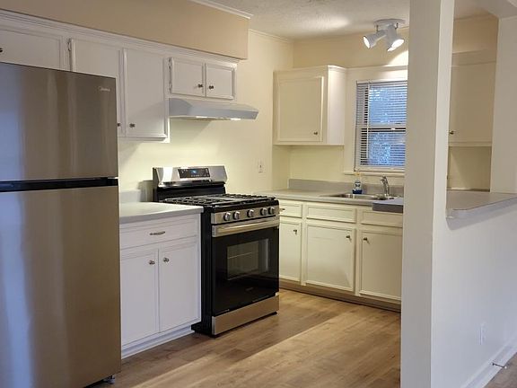 Kitchen with new refrigerator, new oven, and new floors.
