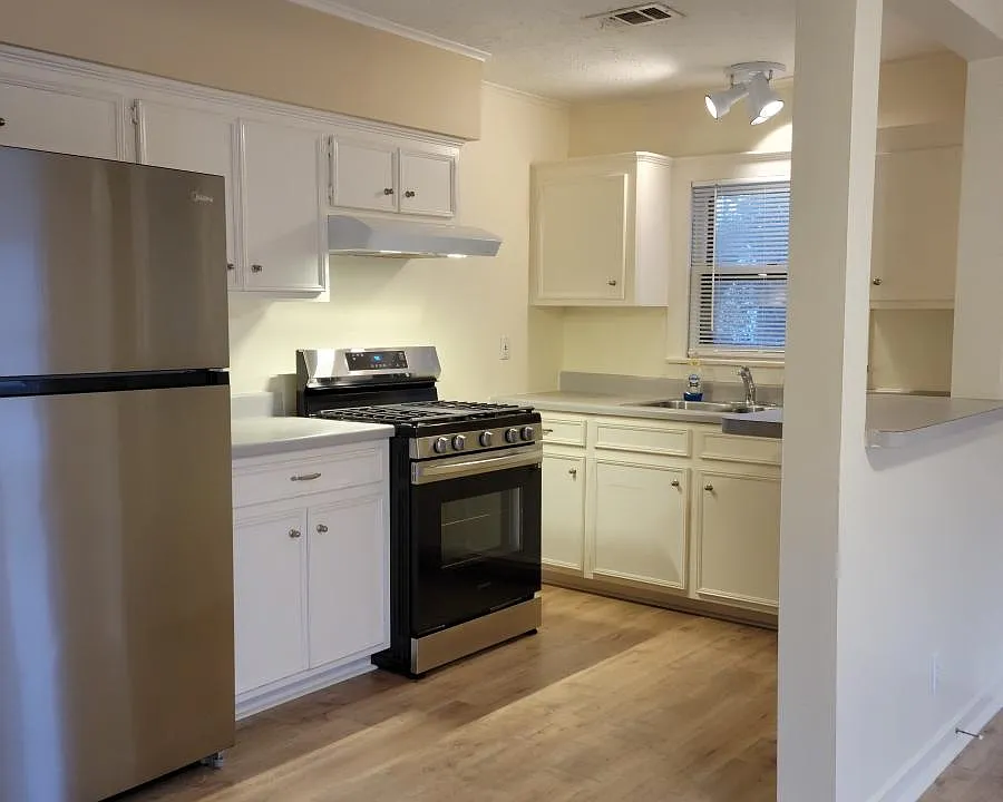 Kitchen with new refrigerator, new oven, and new floors.