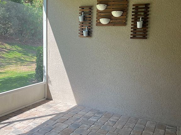 Covered/screened lanai that leads to backyard