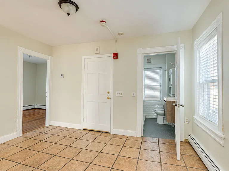 Kitchen area leading to bathroom