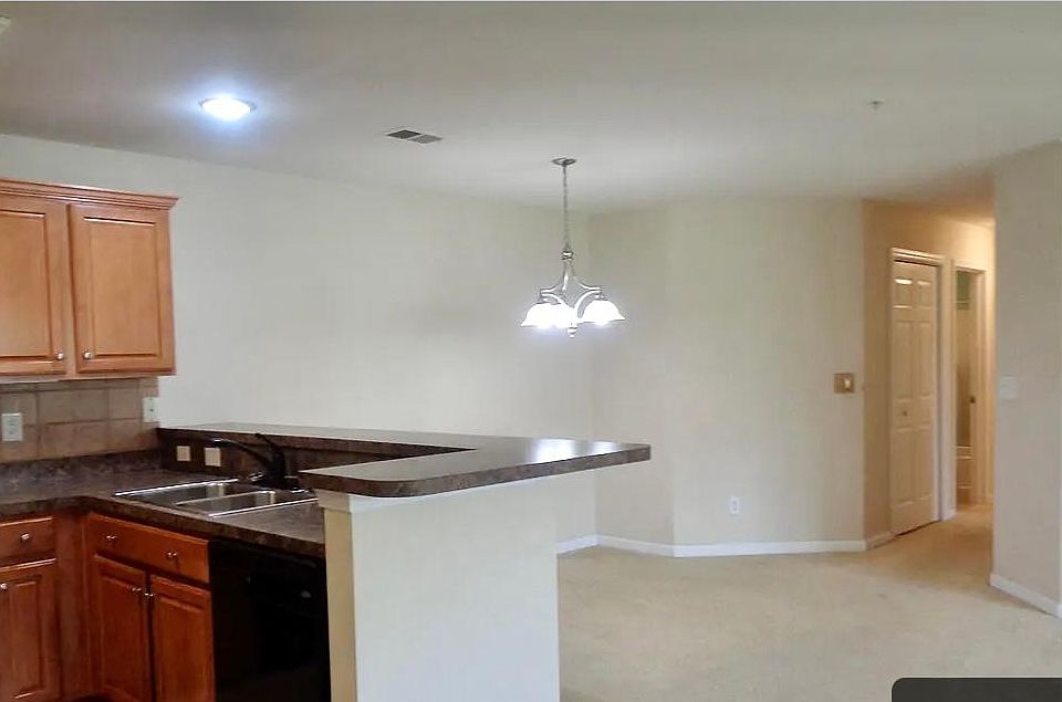 Kitchen has area for stools for countertop dining and dining room space.