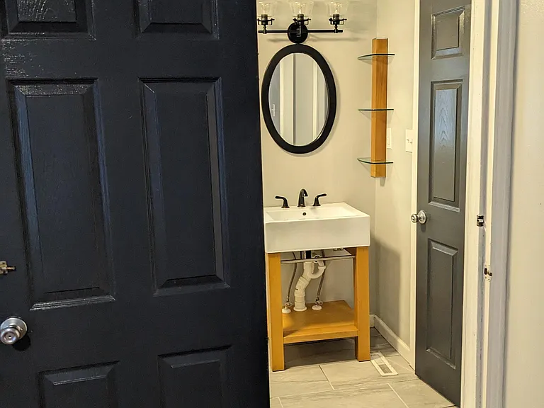 door from adjacent bedroom with second door to entry hall for flexible access