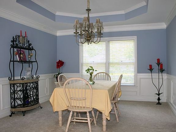 Trey ceiling & wainscoting add character to the extra large formal dining room