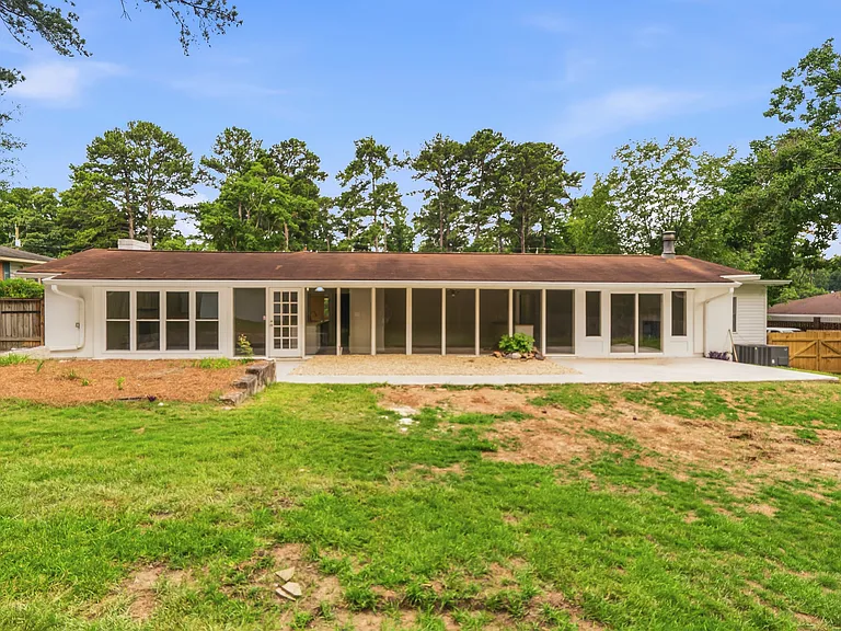 View of fenced backyard and new patio