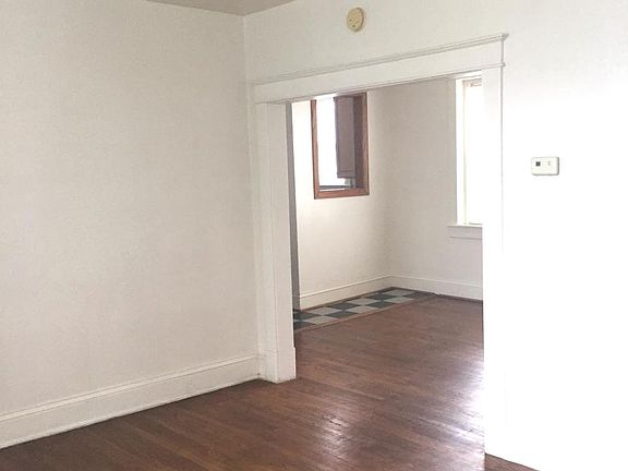 Living room with view into kitchen and dining area