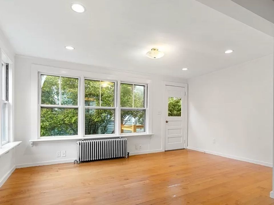 The family room off the kitchen is large and sunny and faces the garden.