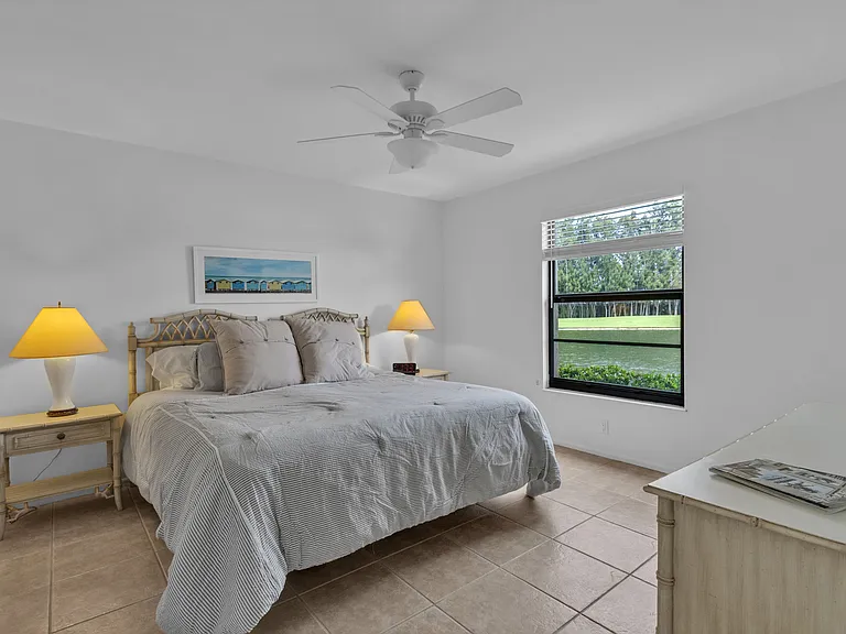 Primary bedroom with lake and golf course views