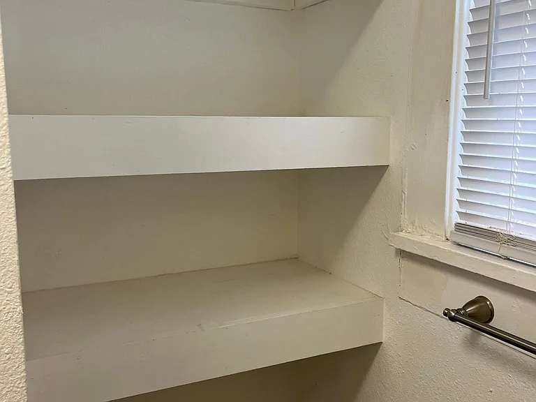 Built-in shelving in bathroom next to window