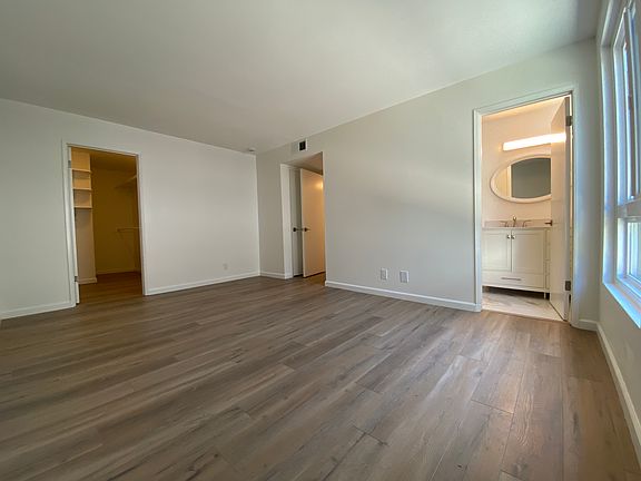 Primary bedroom with en suite bathroom and walk in closet plus a coat closet. Dimensions 15.5 feet by 11feet.