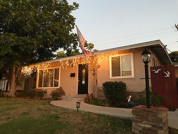 Front of Residence with lighted walk .
