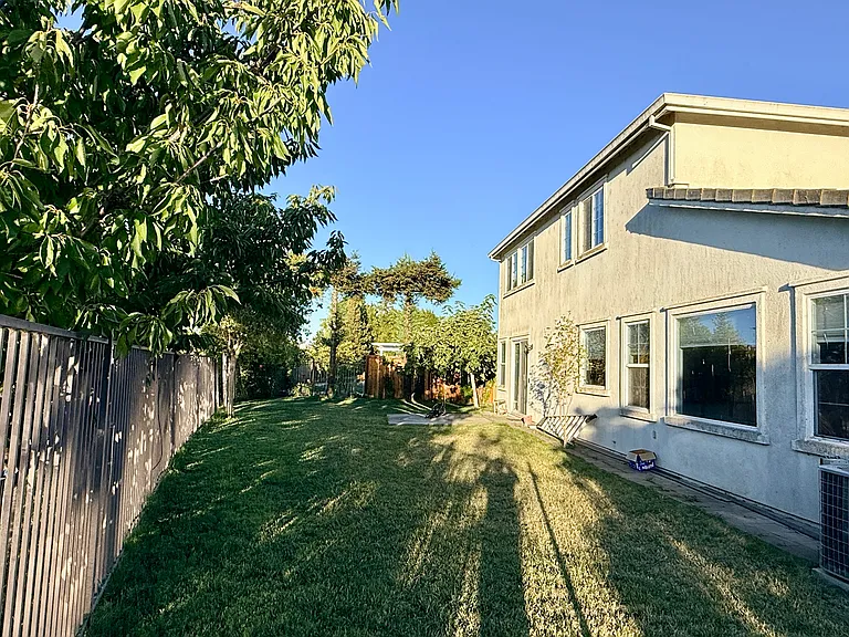 Rear Exterior with a spacious backyard