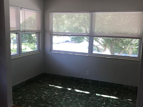 bonus enclosed 4 seasin porch with original Mexican tile floors, newer windows with screens, blinds, lights of light. This room has been used as an office, den, extra guest sleeping etc