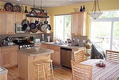 Tiled countertops, gas range/oven, maple cabinets with 42" uppers.