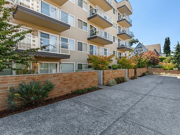Private patios with charming brick walls and landscaped surroundings.