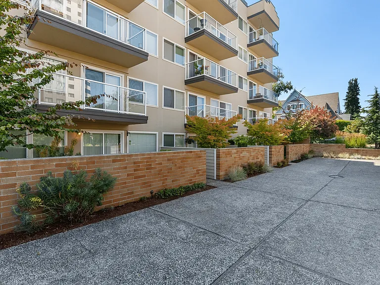 Private patios with charming brick walls and landscaped surroundings.