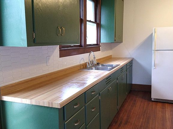 Freshly painted cabinets and a new tile backsplash. There is a lot of storage and counter space here.