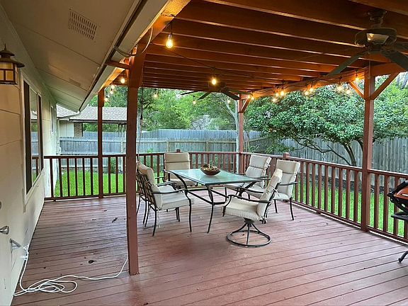 Large, covered back deck with fans