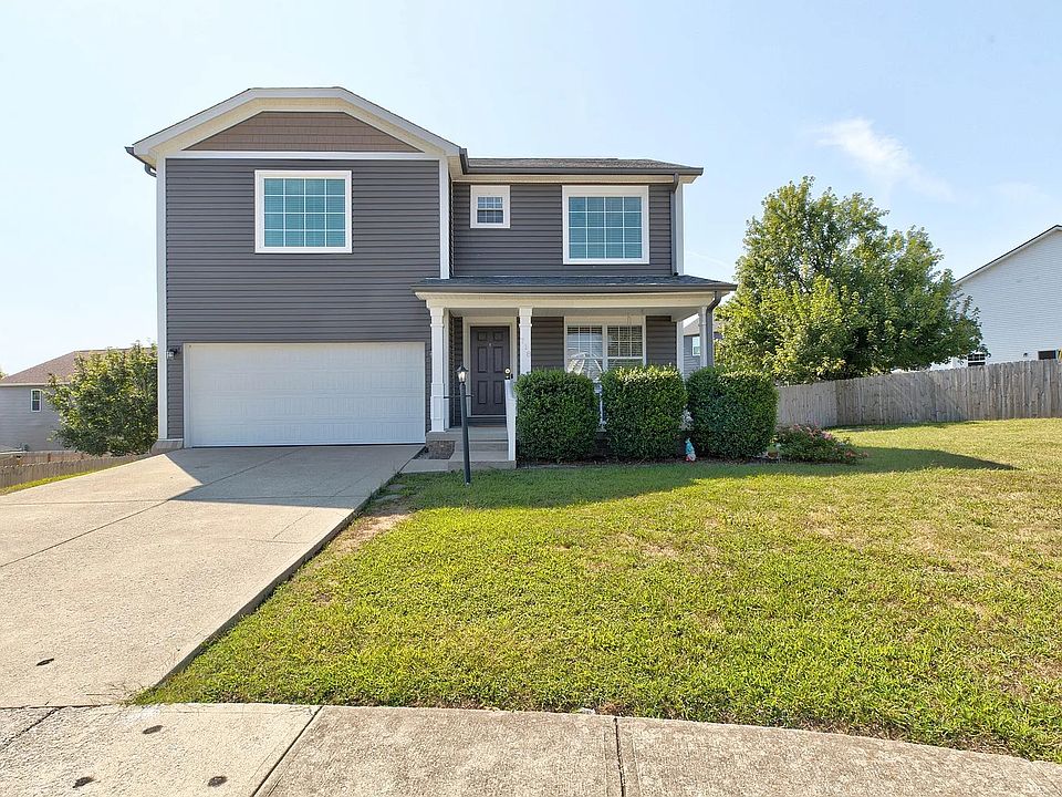 A charming residence featuring a spacious two-car garage and a welcoming porch.