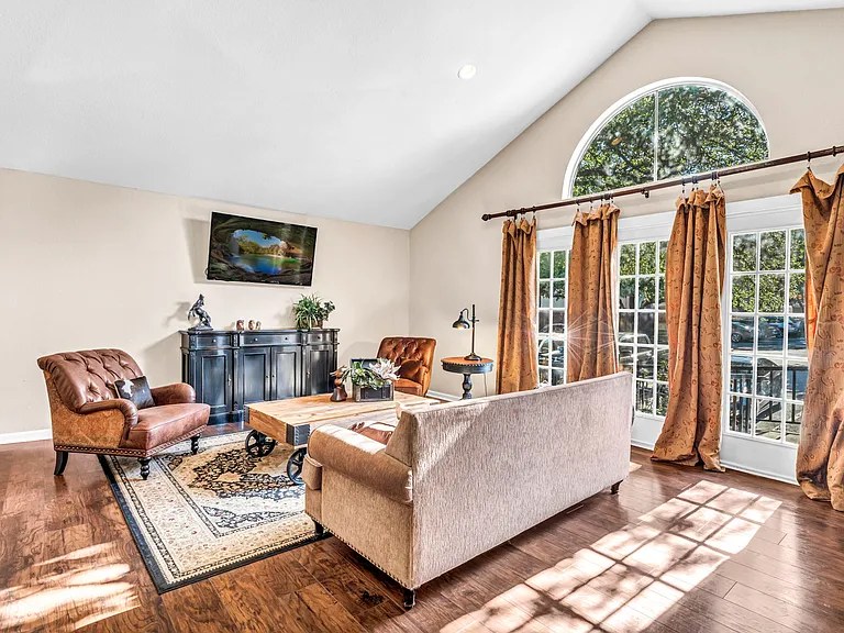 Stylish living area in clubhouse with modern decor and natural lighting.