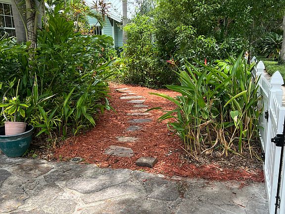 Path in frontyard going to the right hand side of the house