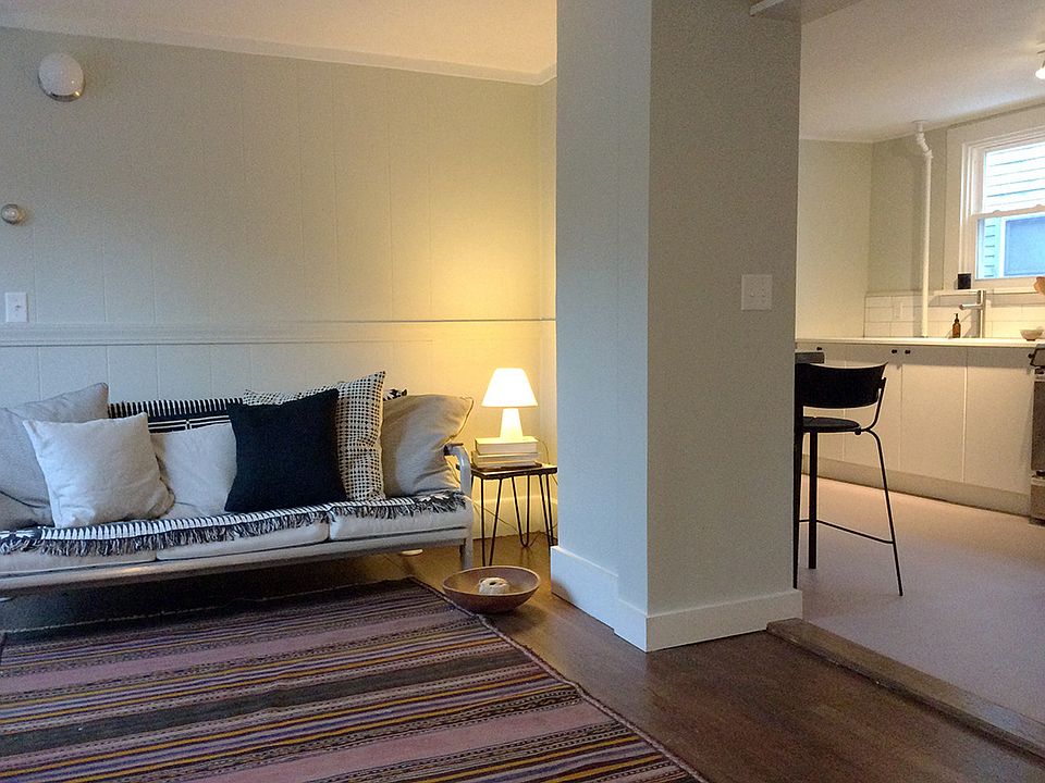 Kitchen opens to living area, hardwood floor