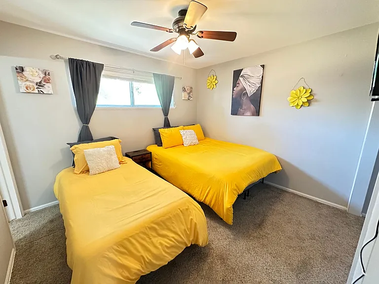 Double the Comfort, Double the Fun _ Our bedroom boasts two single beds, a smart TV, and a spacious closet for a delightful stay.