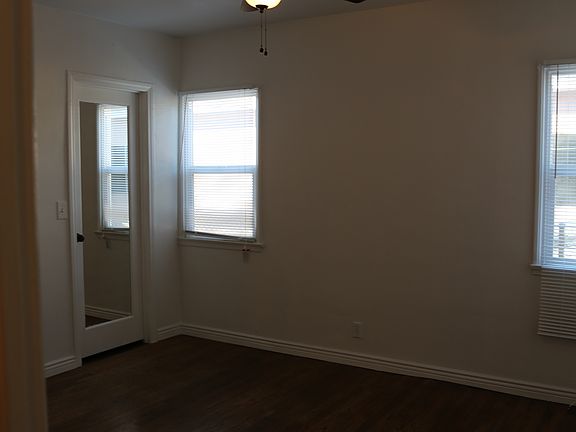 #1 Bedroom with walk in closet and wood floor with ceiling f