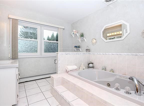 Bathroom with jetted tub and separate shower.