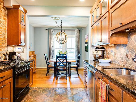 The Kitchen has exposed brick, granite counters and tumbled slate floors.