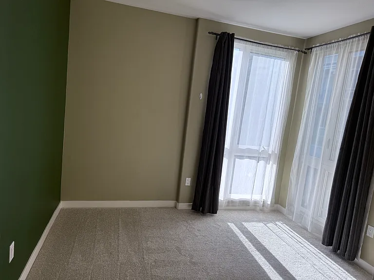 Bedroom two with walk-in closet and accent wall. Natural light through out the day.