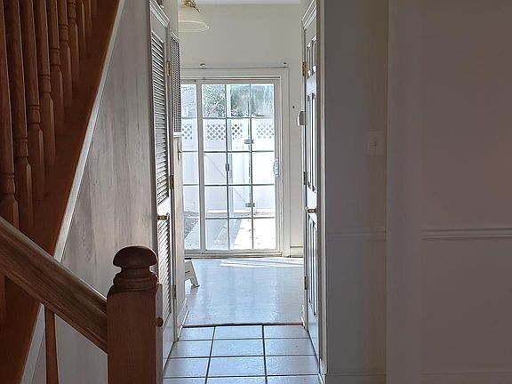 Hallway view towards sliding door in the back on the first floor