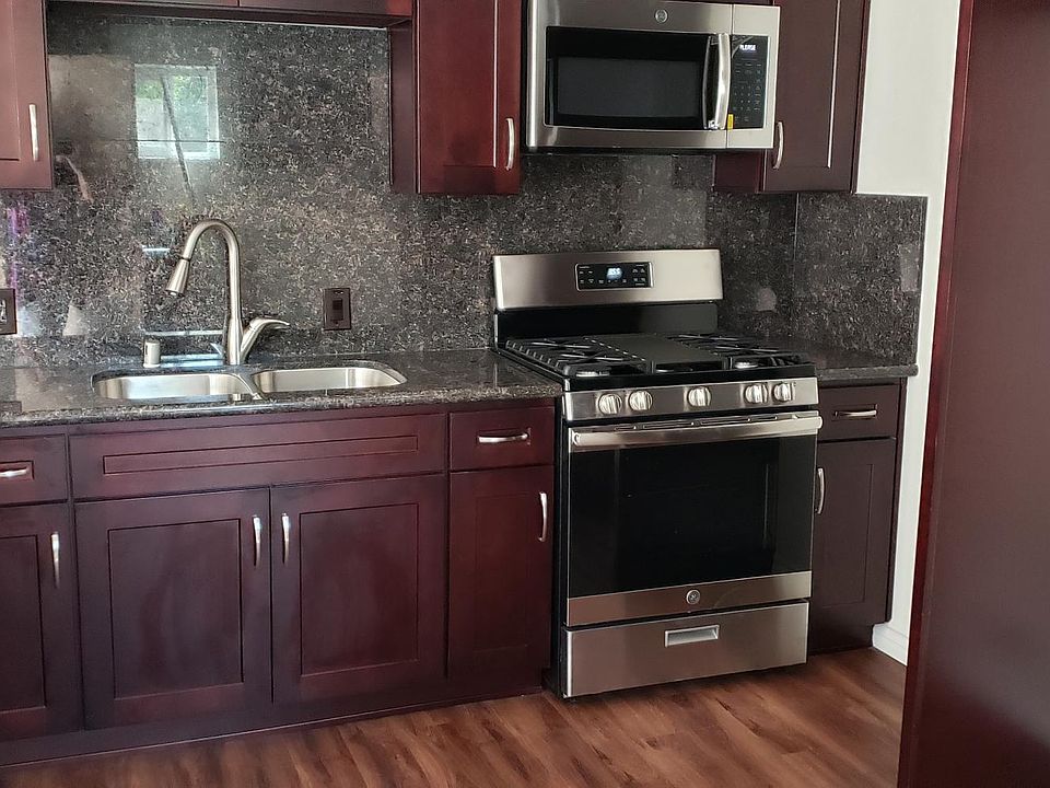 New kitchen, complete with garbage disposal, dishwasher, microwave and gas 5 burner range. Granite counter tops and pantry next to the breakfast bar.