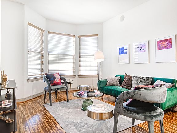 Griffis Uptown apartment living room with wood style flooring.