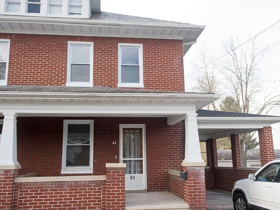 Brick home with attached covered carport.
