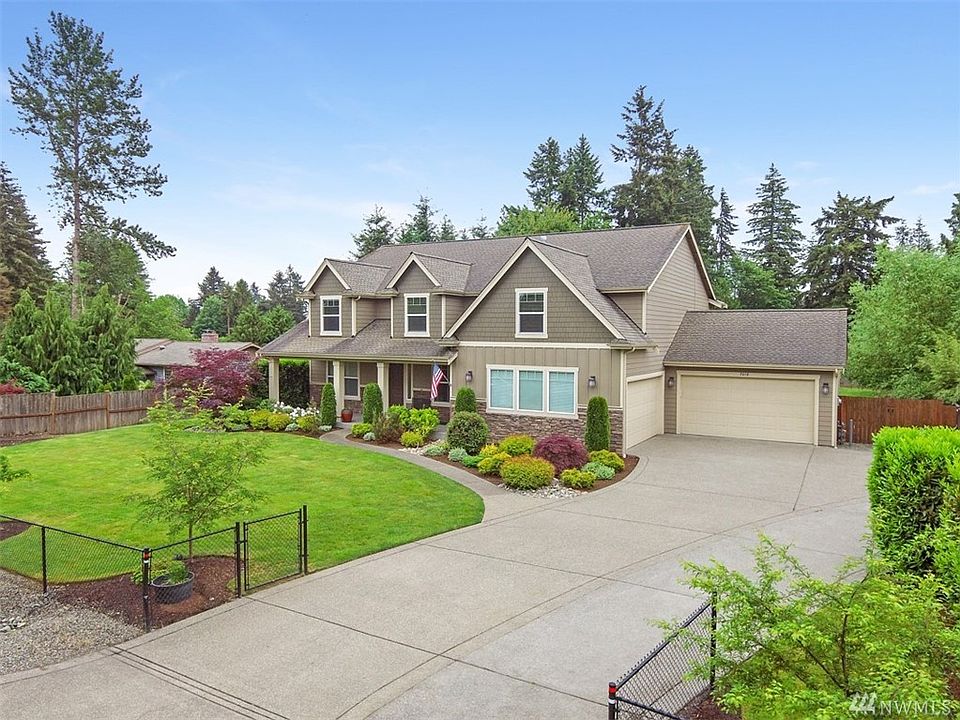 Gorgeous Micon resale with inviting covered porch, 4 car garage, spacious driveway, and situated on a private .45 acre lot.