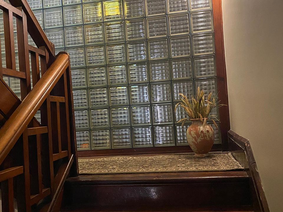 Beautiful mahogany staircase leading to second floor unit.