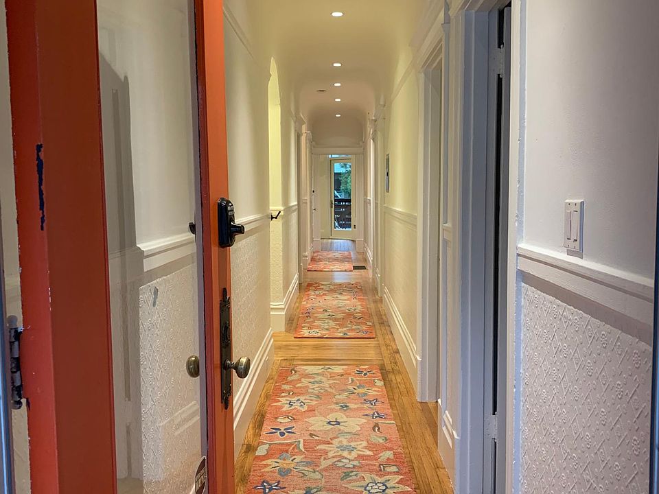Welcome! Front door looking in. Bedrooms on right and left; family room and kitchen at the end of the hall.