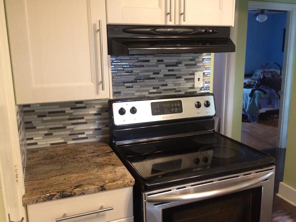 glass backsplash and granite